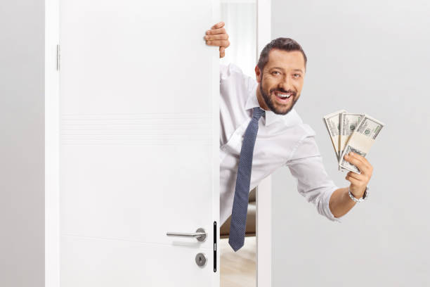 Smiling man holding U.S. dollar bills illustrating how many zeros a million has
